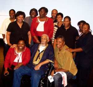Kwame McDonald, seated front center, with members of the Summit-University Stars women’s basketball team he founded and coached Photo by Charles Hallman