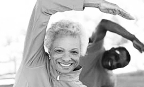 Senior African American Couple Exercising In Park